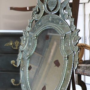 Early 20c Venetian mirror in shield form with classic ornate facets