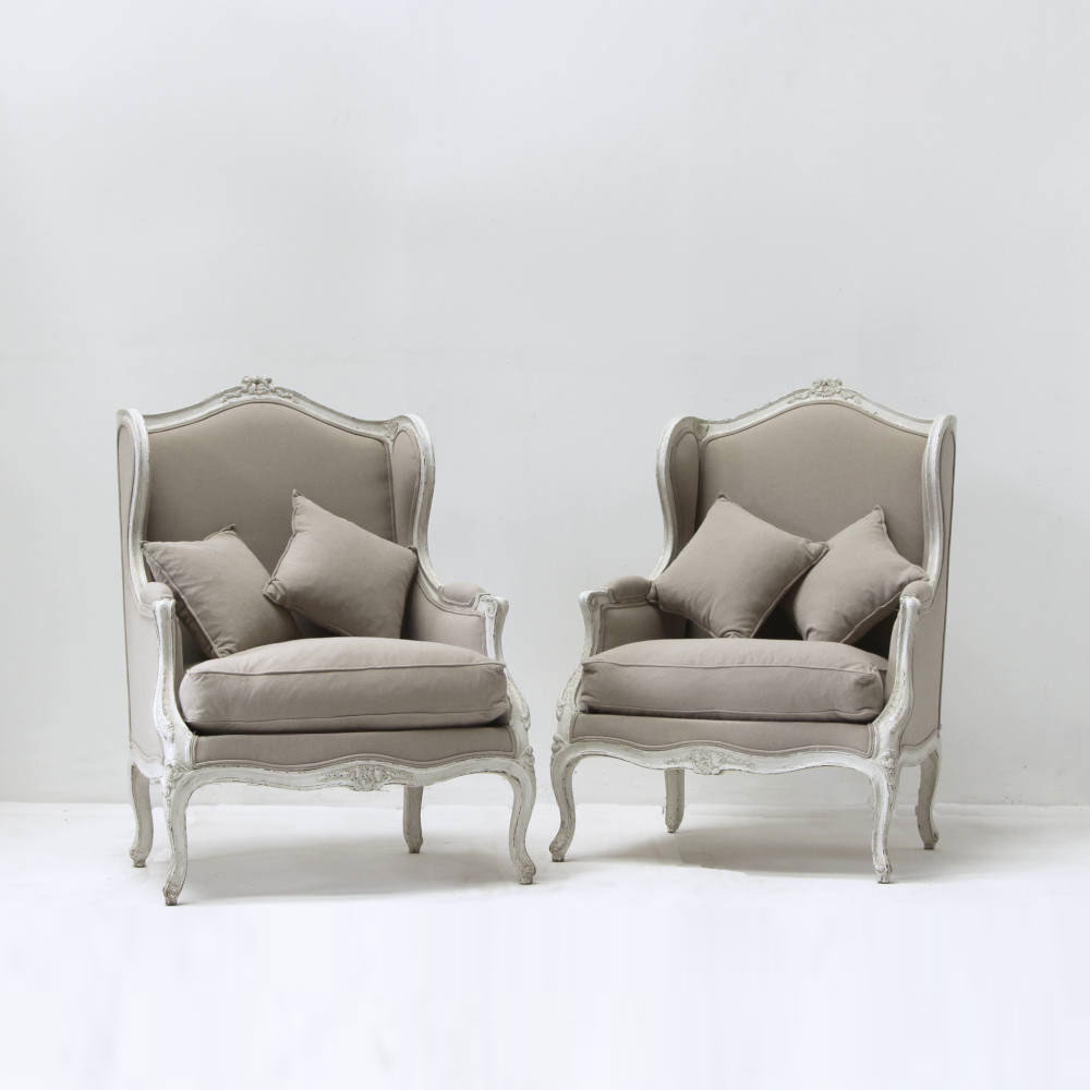 Pair of 19c French bergeres chairs with carved Louis XIV detail and muted taupe linen reupholstery