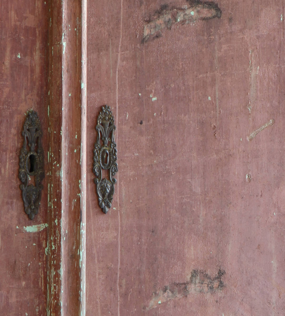 Dutch painted cupboard showing close up detail of the escutcheons
