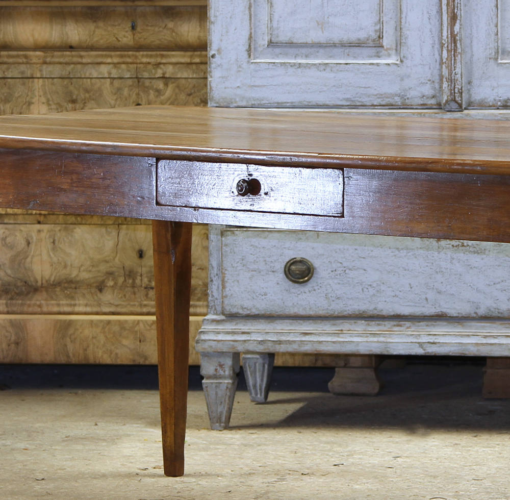 Close up view of the centre drawer in a French farmhouse fruitwood table