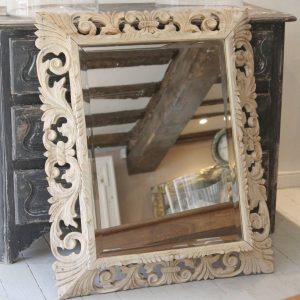 A classic French period mirror with a decorative carved oak frame.