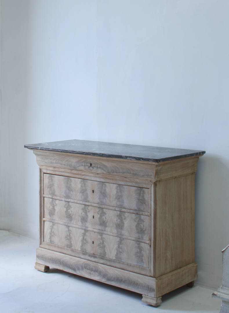 A distant side view of a bleached Louis Philippe commode