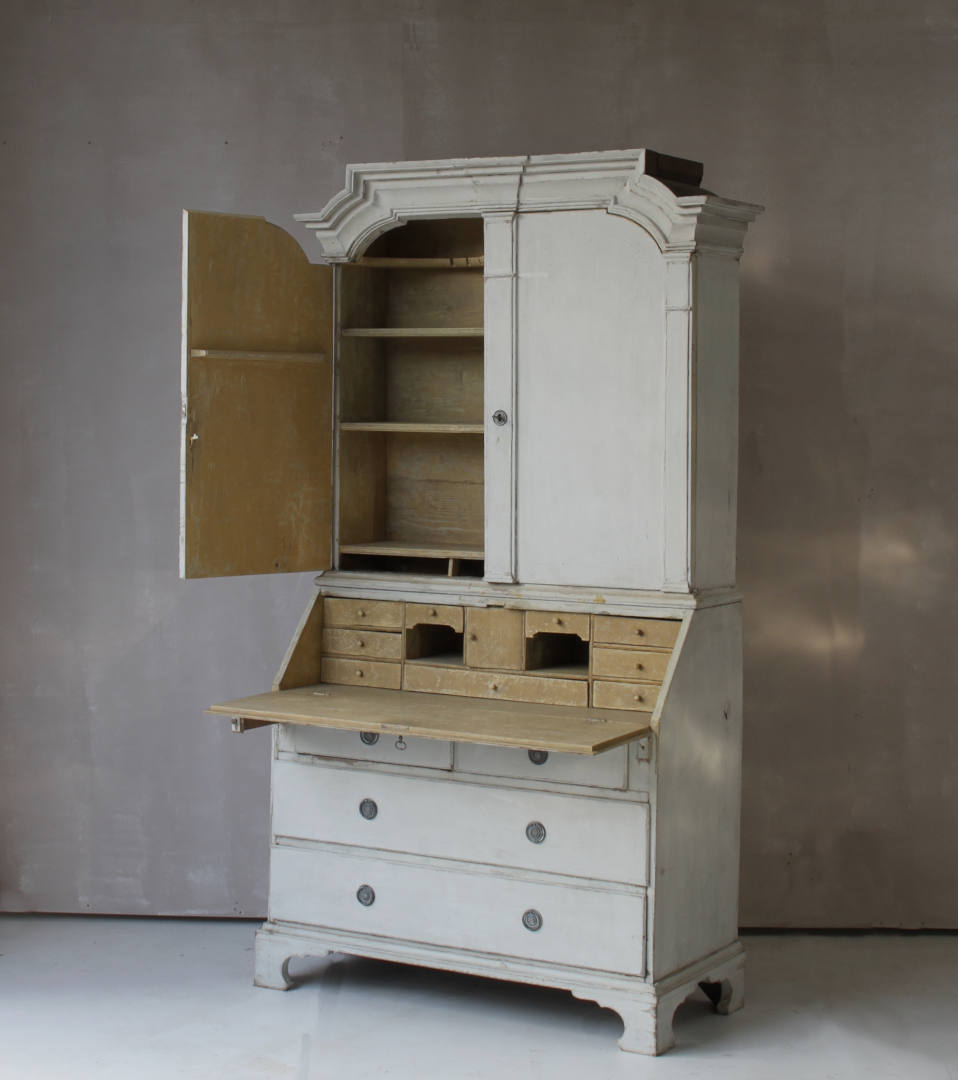 A view of a Swedish secretaire showing the interior of the top and view of the open desk